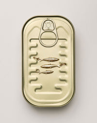 Gold-colored can with sardine charms  