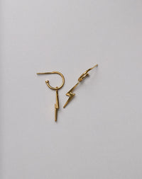 Gold lightning bolt earrings on a white background