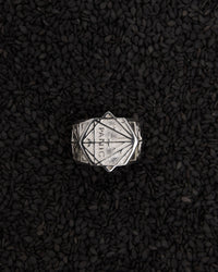 Silver ring with geometric design and the word panic. In collaboration with artist Andrew Mcleod
