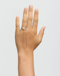 Gold ring with diamonds on a hand on a white background