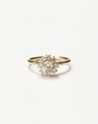 Gold ring with a diamond cluster on a light gray background