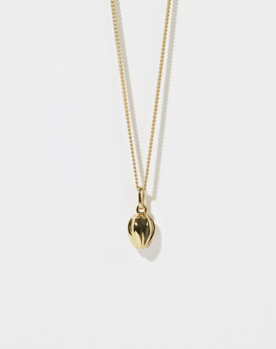 Gold tulip motif necklace with a pendant on a white background