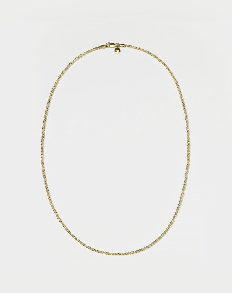 A wheat chain necklace gold plated on a white background.