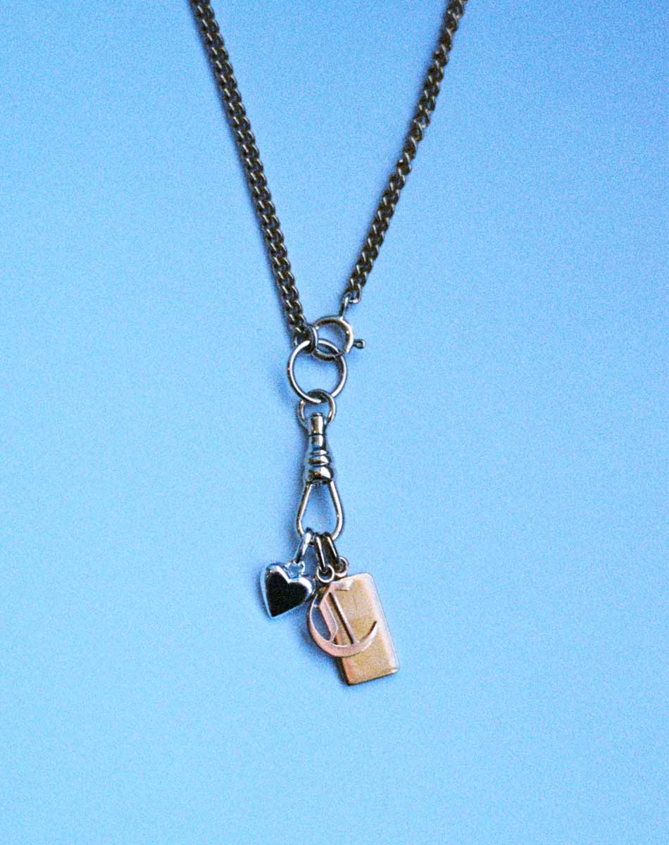A gold swivel chain necklace for attaching your favourite charms, shown with 3 charms