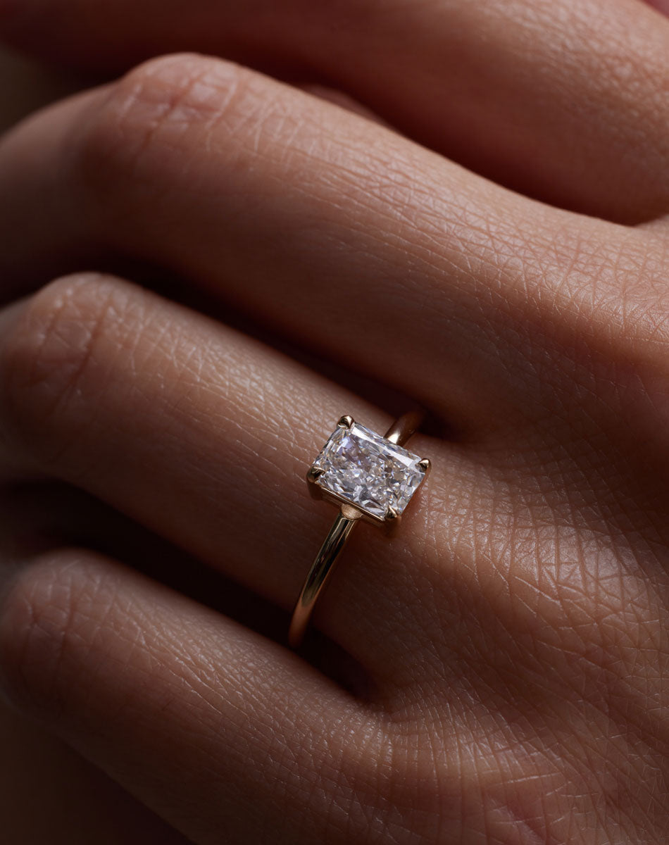 Radiant cut diamond Solitaire engagement ring on hand