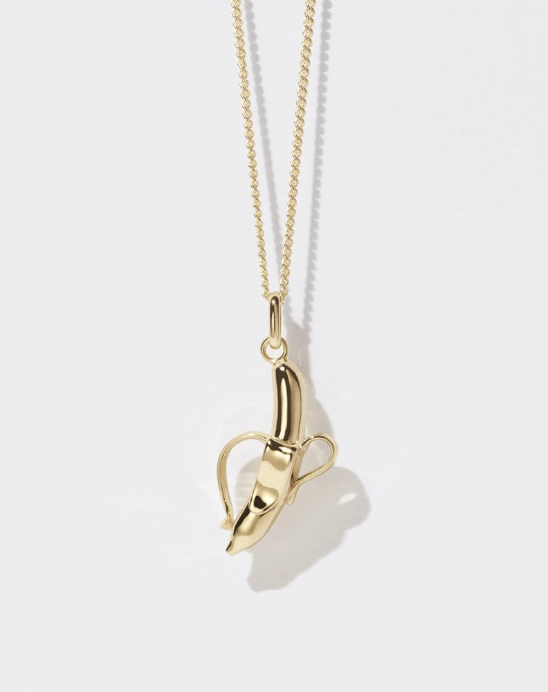 A 23k gold plated banana-shaped charm necklace on a fine gold chain.