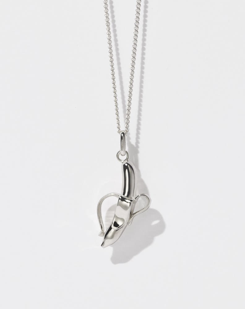 A sterling silver necklace featuring a charm in the shape of a banana