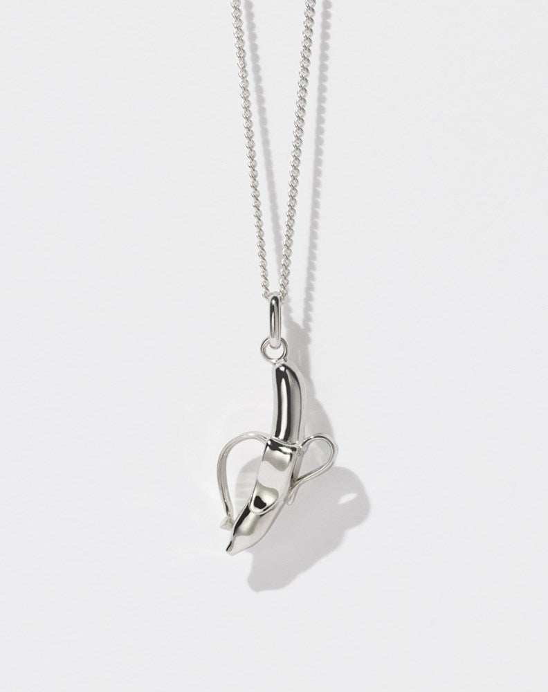 A sterling silver necklace featuring a charm in the shape of a banana