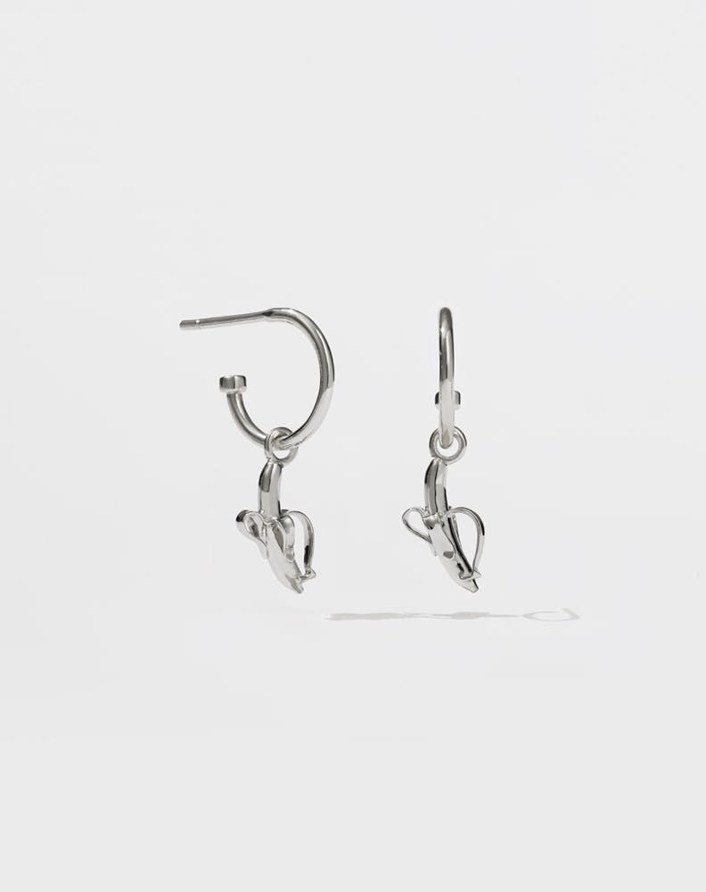 A pair of sterling silver hoop earrings with small banana charms