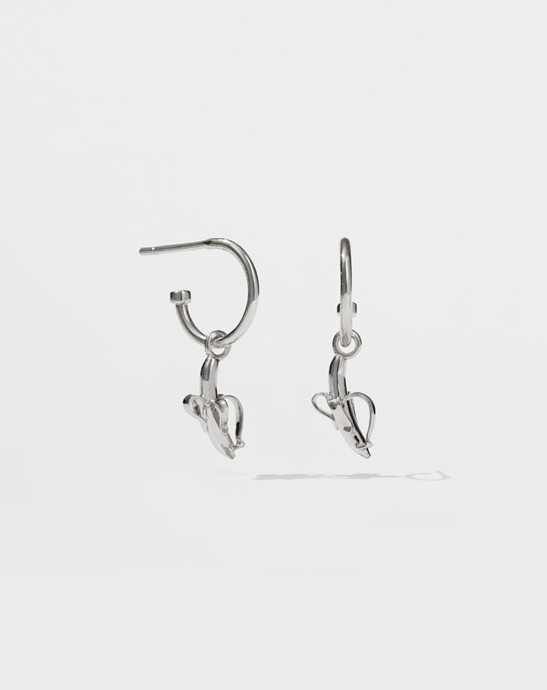 A pair of sterling silver hoop earrings with small banana charms