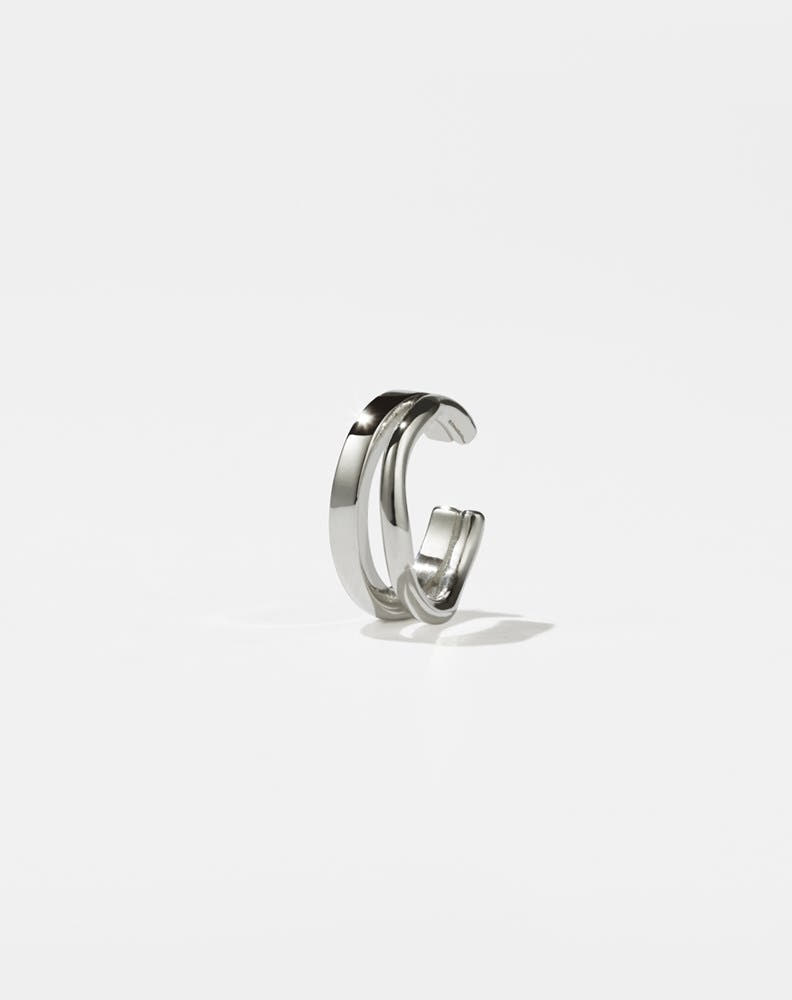 A sterling silver ear cuff with a minimalist and curved design 