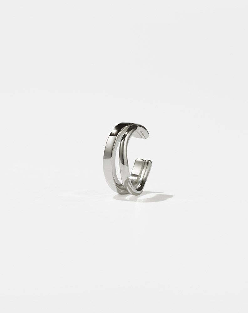 A sterling silver ear cuff with a minimalist and curved design 