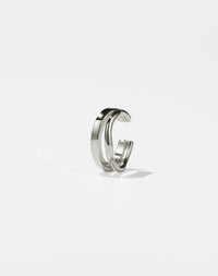 A sterling silver ear cuff with a minimalist and curved design 