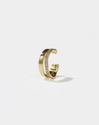 A gold-colored hoop ear cuff with a pavé set of diamonds 