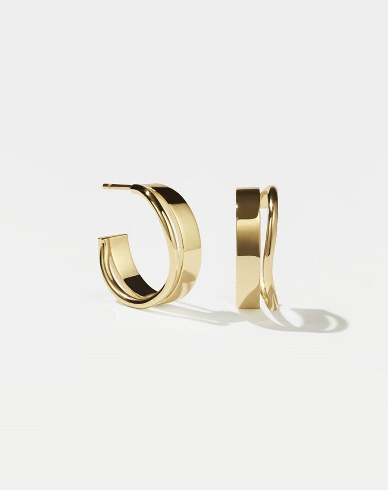 A pair of gold-plated hoop earrings, showcasing a minimalist and organic design.