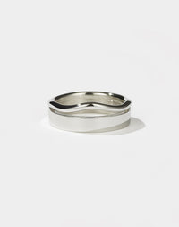 A sterling silver ring with a flat, minimalist band and an organic, curvy rounded band.
