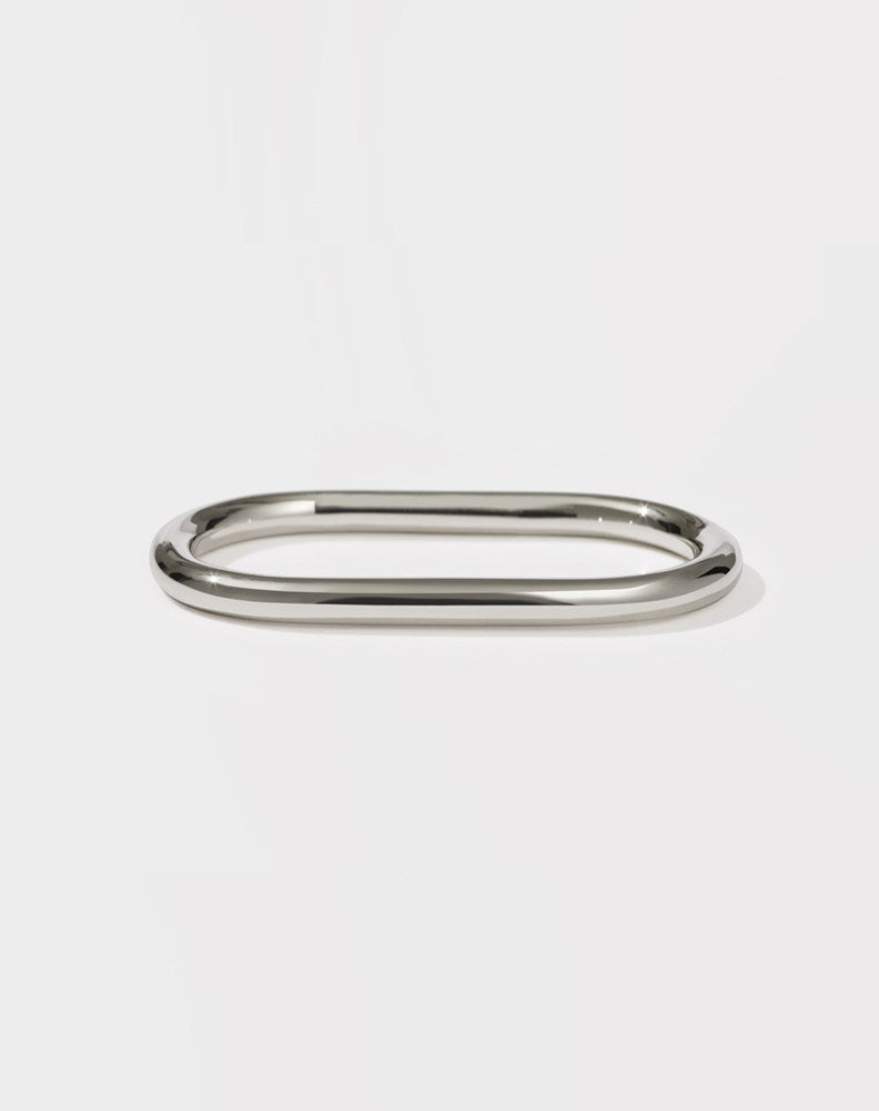 A minimalist round and endless sterling silver band designed to fit across two fingers.