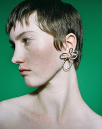 Silver flower earrings in two sizes worn by model