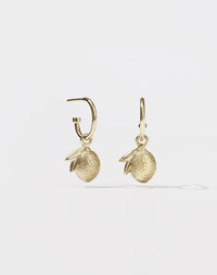A pair of gold hoop earrings with lemon charm pendants attached