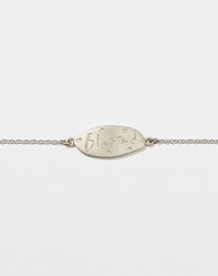 Meadowlark Jewellery’s Blessed Bracelet in Sterling Silver. A meaningful talisman for life’s journey, to serve as a daily reminder to honour the present and embrace gratitude for the quiet abundance all around us. A classic name tag in a matte, brushed texture inspired by ancient heirlooms hung from a fine diamond curb chain. From the Dreams collection.