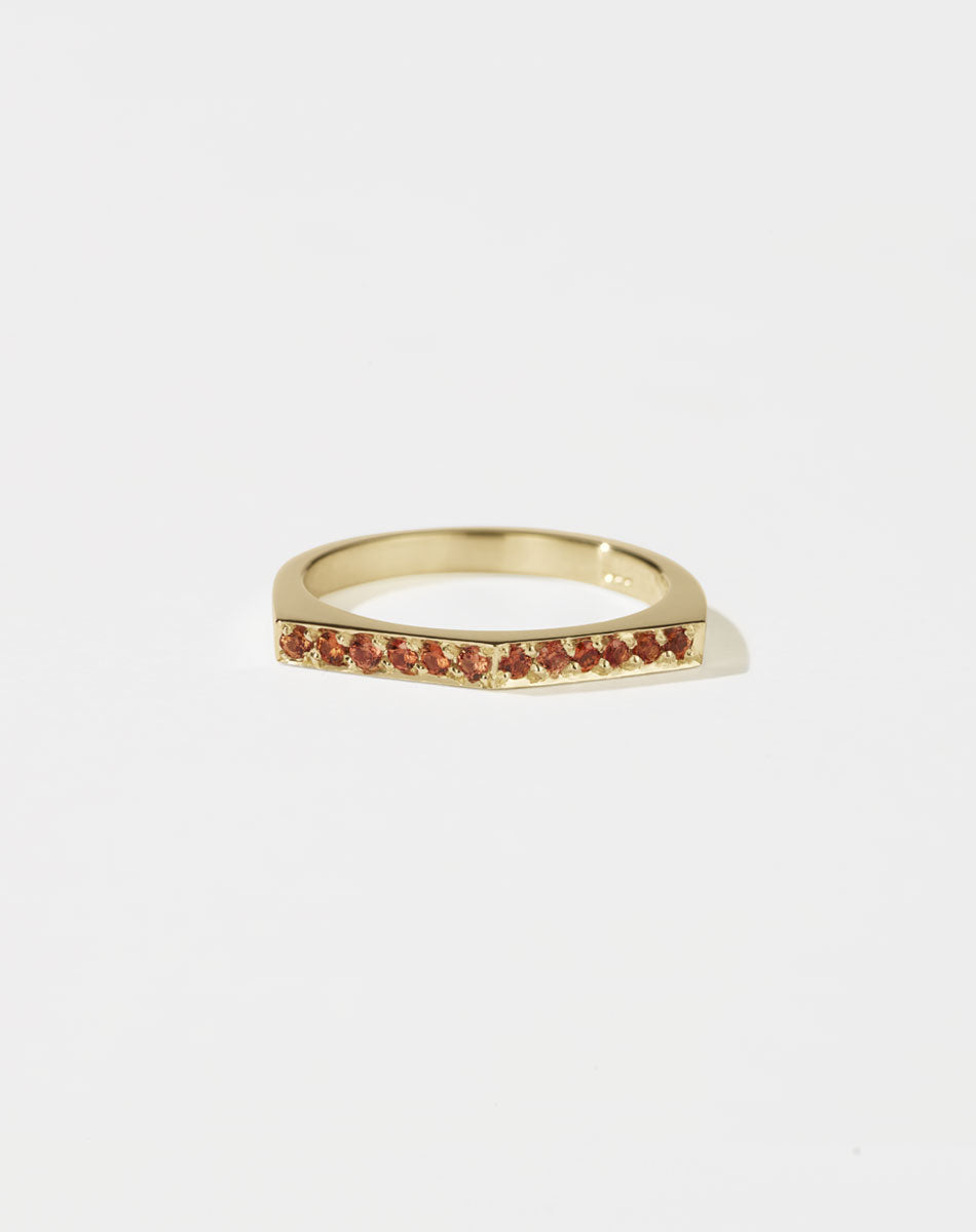 Meadowlark Jewellery’s architectural Geo Ring Arc in 9ct Yellow Gold, pave set with twelve round brilliant cut orange sapphires atop a 1.5mm. A striking piece designed to be worn with the Geo Flat & Geo Point rings, or alone for a refined and minimal look. From the Dreams collection.