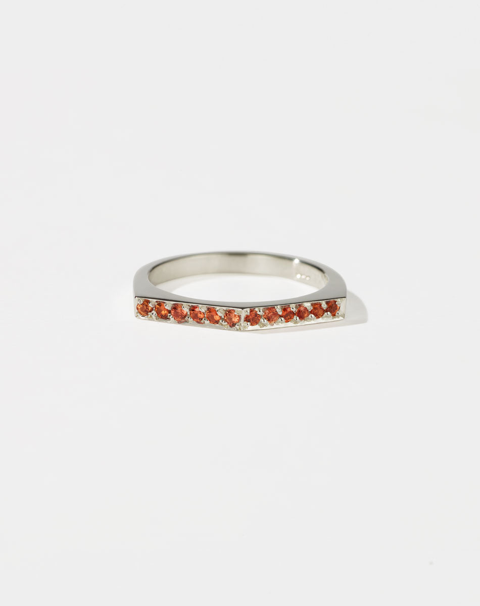 Meadowlark Jewellery’s architectural Geo Ring Arc in Sterling Silver, pave set with twelve round brilliant cut orange sapphires atop a 1.5mm. A striking piece designed to be worn with the Geo Flat & Geo Point rings, or alone for a refined and minimal look. From the Dreams collection.