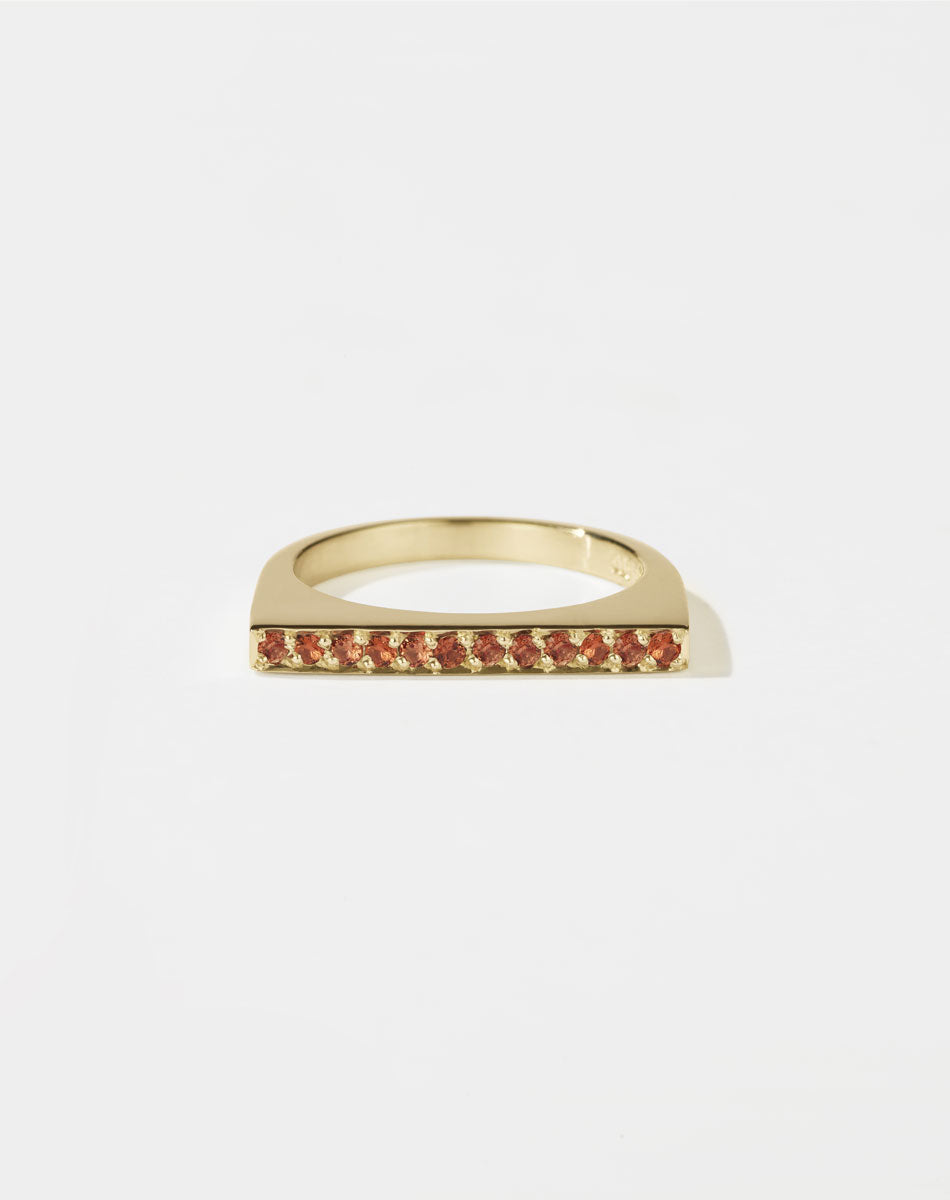 Meadowlark Jewellery’s architectural Geo Ring Flat in 9ct Yellow Gold, pave set with twelve round brilliant cut orange sapphires atop a 1.5mm. A striking piece designed to be worn with the Geo Arc & Geo Point rings, or alone for a refined and minimal look. From the Dreams collection.