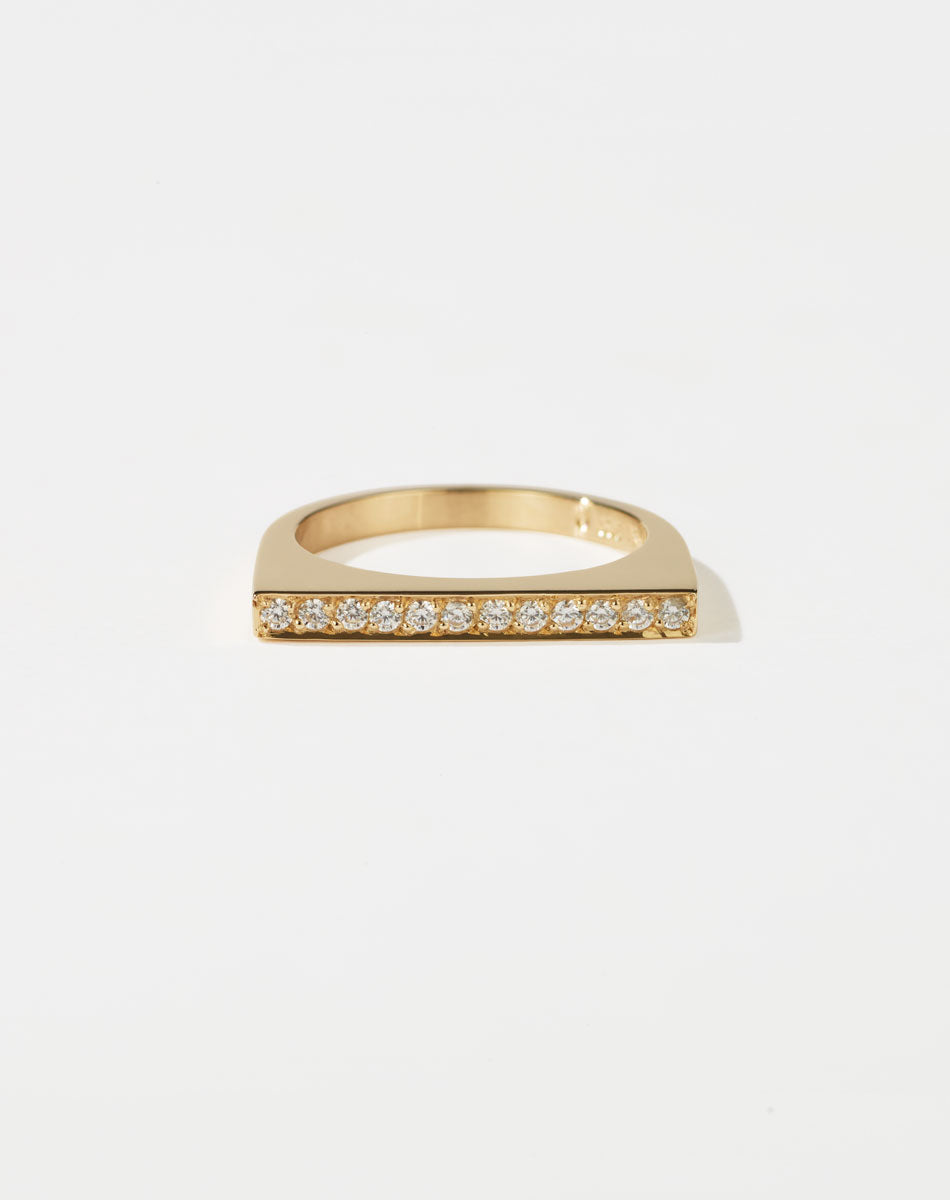 Meadowlark Jewellery’s architectural Geo Ring Flat in 9ct Yellow Gold, pave set with twelve round brilliant cut white diamonds atop a 1.5mm. A striking piece designed to be worn with the Geo Arc & Geo Point rings, or alone for a refined and minimal look. From the Dreams collection.