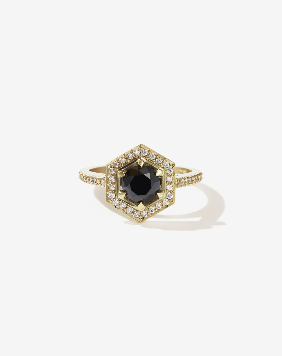Meadowlark Jewellery’s iconic Hex Engagement Ring 0.5ct in 14ct Yellow Gold, claw set with 0.61ct round brilliant cut black diamond centre stone, surrounded by a hexagon halo of pave set white diamonds. One of our most beloved and modern Ceremonial designs, made to order in New Zealand. Pair with our bestseller, the Diamond Eternity Band.