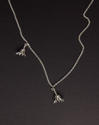 Meadowlark Jewellery’s Magda Two Charm Necklace in Sterling Silver. Two delicate, bell-shaped flower charms suspended from a fine diamond curb chain. A minimalist ode to blooming and the enduring cycles of life. From the Dreams collection.