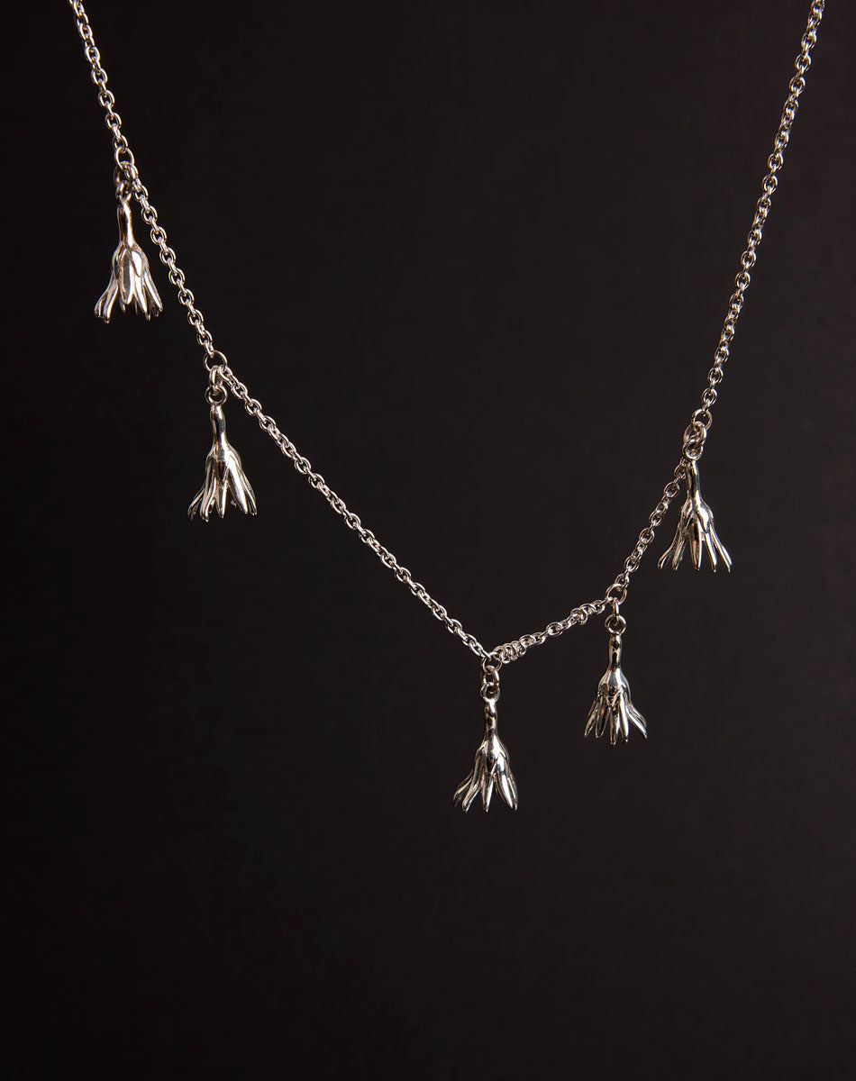 Meadowlark Jewellery’s Magda Five Charm Necklace in Sterling Silver. Five delicate, bell-shaped flower charms suspended from a fine diamond curb chain. A poetic celebration of growth, transformation, and the eternal rhythm of nature. A statement of quiet strength and beauty. From the Dreams collection.