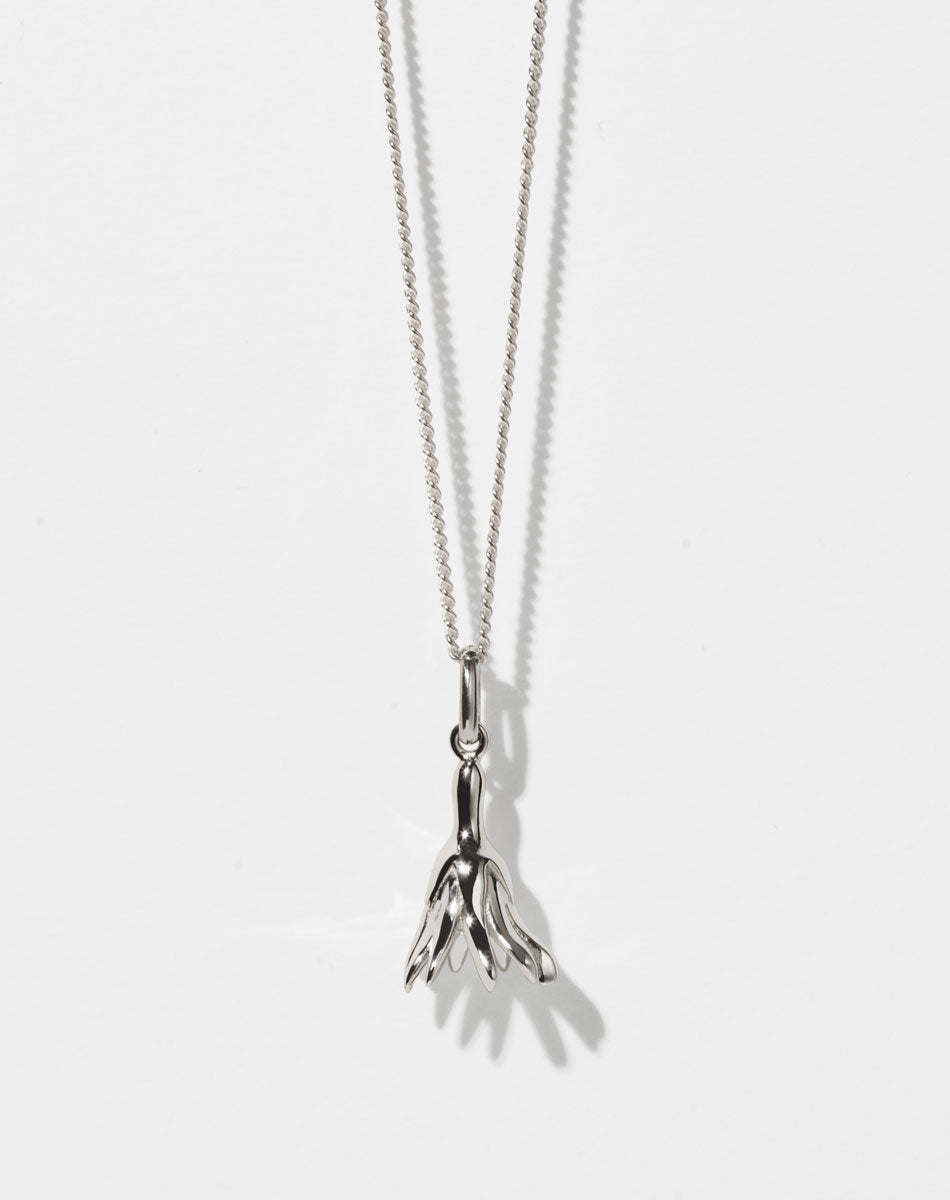 Meadowlark Jewellery’s Magda Charm Necklace in Sterling Silver. A single bell-shaped flower charm suspended from a fine diamond curb chain. A symbol of quiet transformation and the tender strength of nature. From the Dreams collection.