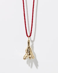 Meadowlark Jewellery’s Magda String Necklace in 9ct Yellow Gold. A single bell-shaped flower charm suspended from a vibrant red silk string. A striking and unconventional piece that can be styled at any length, from choker to torso. From the Dreams collection.