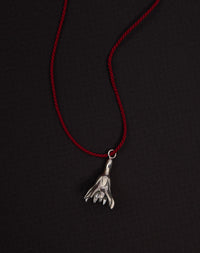 Meadowlark Jewellery’s Magda String Necklace in Sterling Silver. A single bell-shaped flower charm suspended from a vibrant red silk string. A striking and unconventional piece that can be styled at any length, from choker to torso. From the Dreams collection.