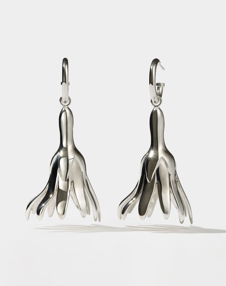 Meadowlark Jewellery’s sculptural Magda Drop Earrings Large in Sterling Silver. Bell-shaped flowers suspended from our classic Aria Hoop Earrings. A bold, deliberately off-beat statement. From the Dreams collection.