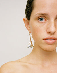 Meadowlark Jewellery’s sculptural Magda Drop Earrings Large in Sterling Silver. Bell-shaped flowers suspended from our classic Aria Hoop Earrings. A bold, deliberately off-beat statement. From the Dreams collection.