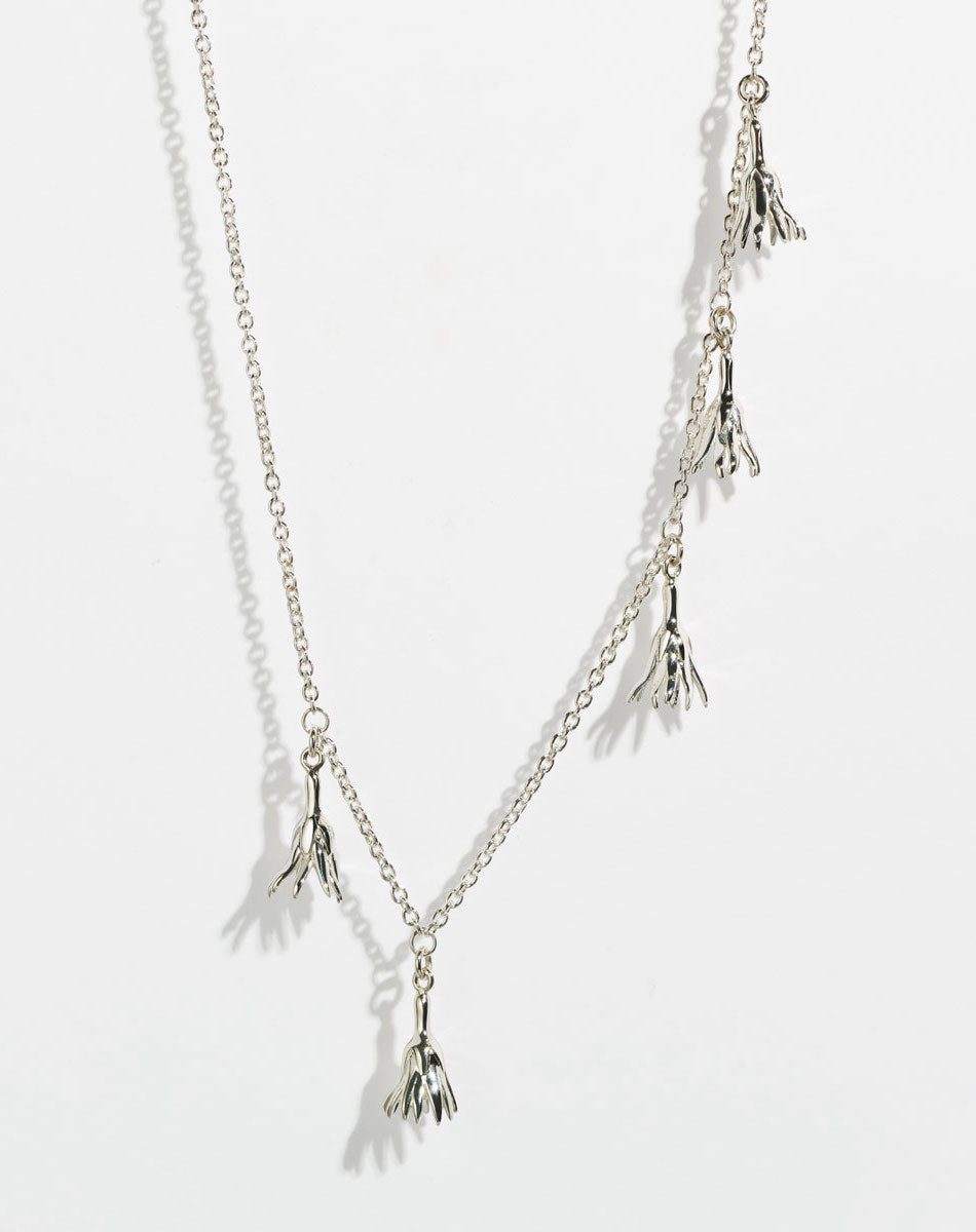 Silver necklace with tassel pendants in the shape of flowers
