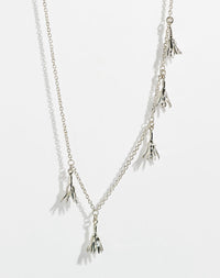 Silver necklace with tassel pendants in the shape of flowers