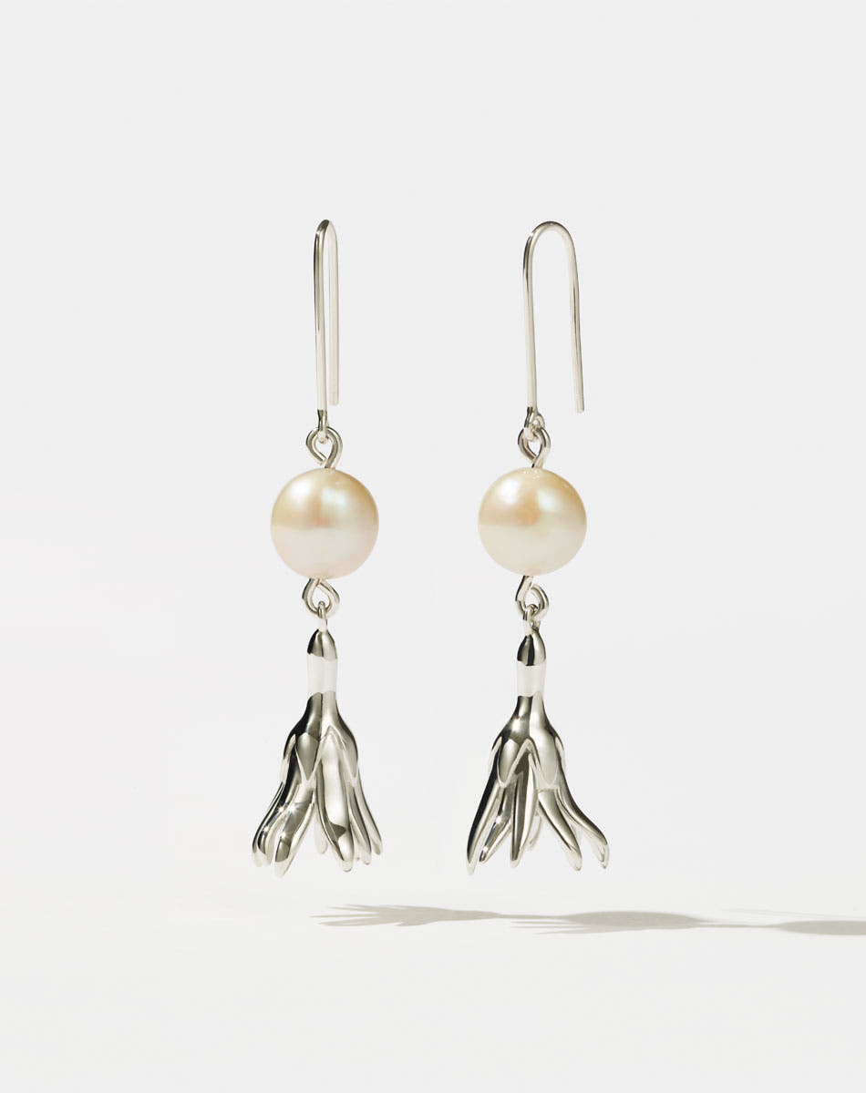 Meadowlark Jewellery’s refined Magda Pearl Earrings in Sterling Silver. An ethereal, bell-shaped flower charm suspended from a lustrous round, freshwater pearl – bringing an air of quiet luxury to any ensemble. Light-catching and dreamlike. From the Dreams collection.