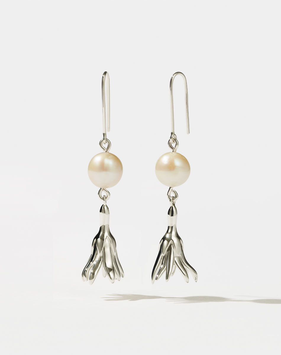 Meadowlark Jewellery’s refined Magda Pearl Earrings in Sterling Silver. An ethereal, bell-shaped flower charm suspended from a lustrous round, freshwater pearl – bringing an air of quiet luxury to any ensemble. Light-catching and dreamlike. From the Dreams collection.