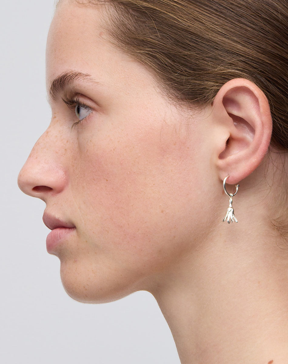 Meadowlark Jewellery’s timeless, everyday Magda Signature Hoop Earrings in Sterling Silver. An enchanting, bell-shaped flower charm suspended from classic signature hoops. From the Dreams collection.