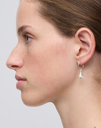 Meadowlark Jewellery’s timeless, everyday Magda Signature Hoop Earrings in Sterling Silver. An enchanting, bell-shaped flower charm suspended from classic signature hoops. From the Dreams collection.