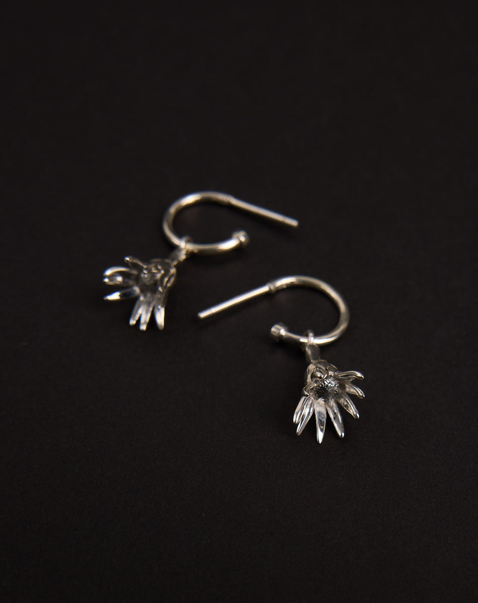 Meadowlark Jewellery’s timeless, everyday Magda Signature Hoop Earrings in Sterling Silver. An enchanting, bell-shaped flower charm suspended from classic signature hoops. From the Dreams collection.
