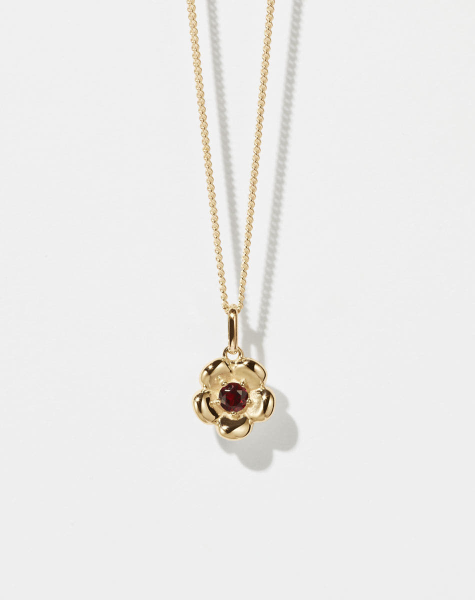 Meadowlark Jewellery’s floral Posie Charm Necklace in 23k Gold Plated Sterling Silver or 9ct Yellow Gold, set with a single round brilliant cut African Garnet stone. Hung from a fine diamond curb chain. Inspired by classic floral motifs and our beloved Alba designs, a timeless symbol of grace, growth and renewal. Celebrating life’s continual renewal. From the Dreams collection.