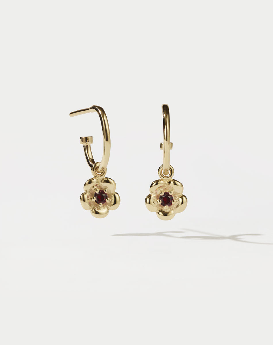 Meadowlark Jewellery’s floral Posie Signature Hoop Earrings in 23k Gold Plated Sterling Silver or 9ct Yellow Gold, set with a single round brilliant cut African Garnet stone. Hung from classic signature hoop earrings. Inspired by classic floral motifs and our beloved Alba designs, a timeless symbol of grace, growth and renewal. Celebrating life’s continual renewal. From the Dreams collection.