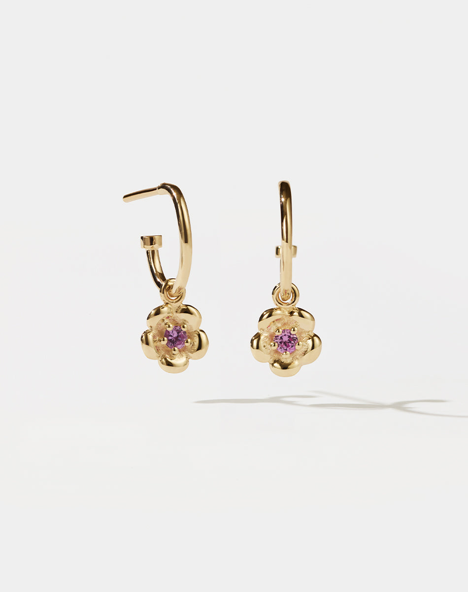 Meadowlark Jewellery’s floral Posie Signature Hoop Earrings in 23k Gold Plated Sterling Silver or 9ct Yellow Gold, set with a single round brilliant cut Pink Sapphire stone. Hung from classic signature hoop earrings. Inspired by classic floral motifs and our beloved Alba designs, a timeless symbol of grace, growth and renewal. Celebrating life’s continual renewal. From the Dreams collection.