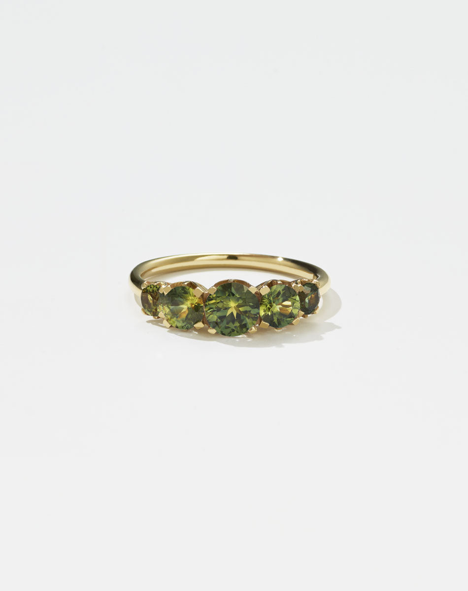 A classic yellow gold, five stone diamond engagement ring. Set with green sapphires.