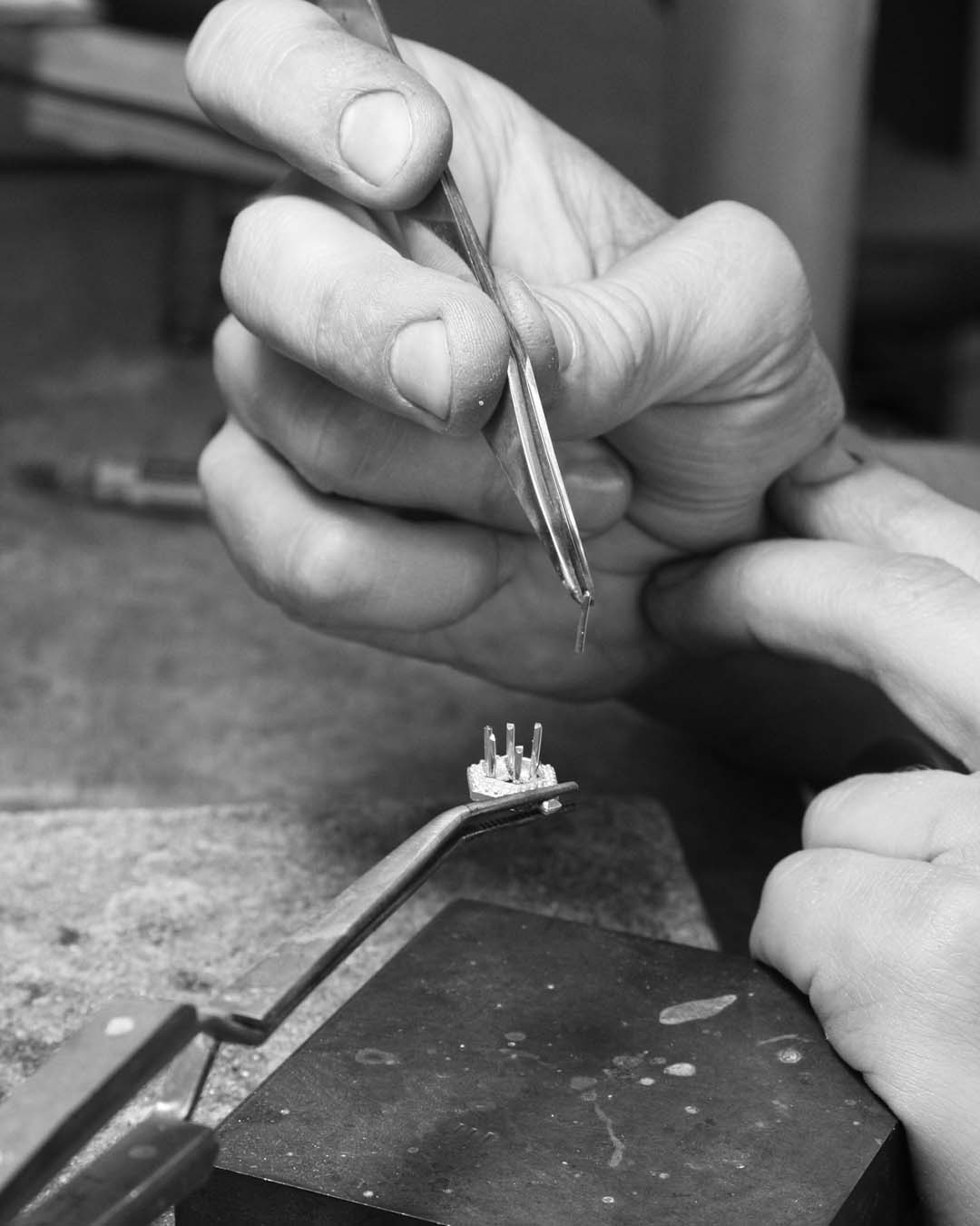 Applying claws to the setting. To begin, Lukas, our Sample Jeweller cuts six pieces of metal wire for claws and solders (joins) these to the setting.