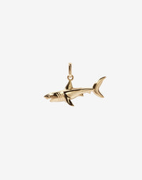A gold shark charm with an oval jump ring for attachment.