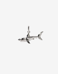 A sterling silver charm in the shape of a shark with an oval jump ring for attaching to a chain.